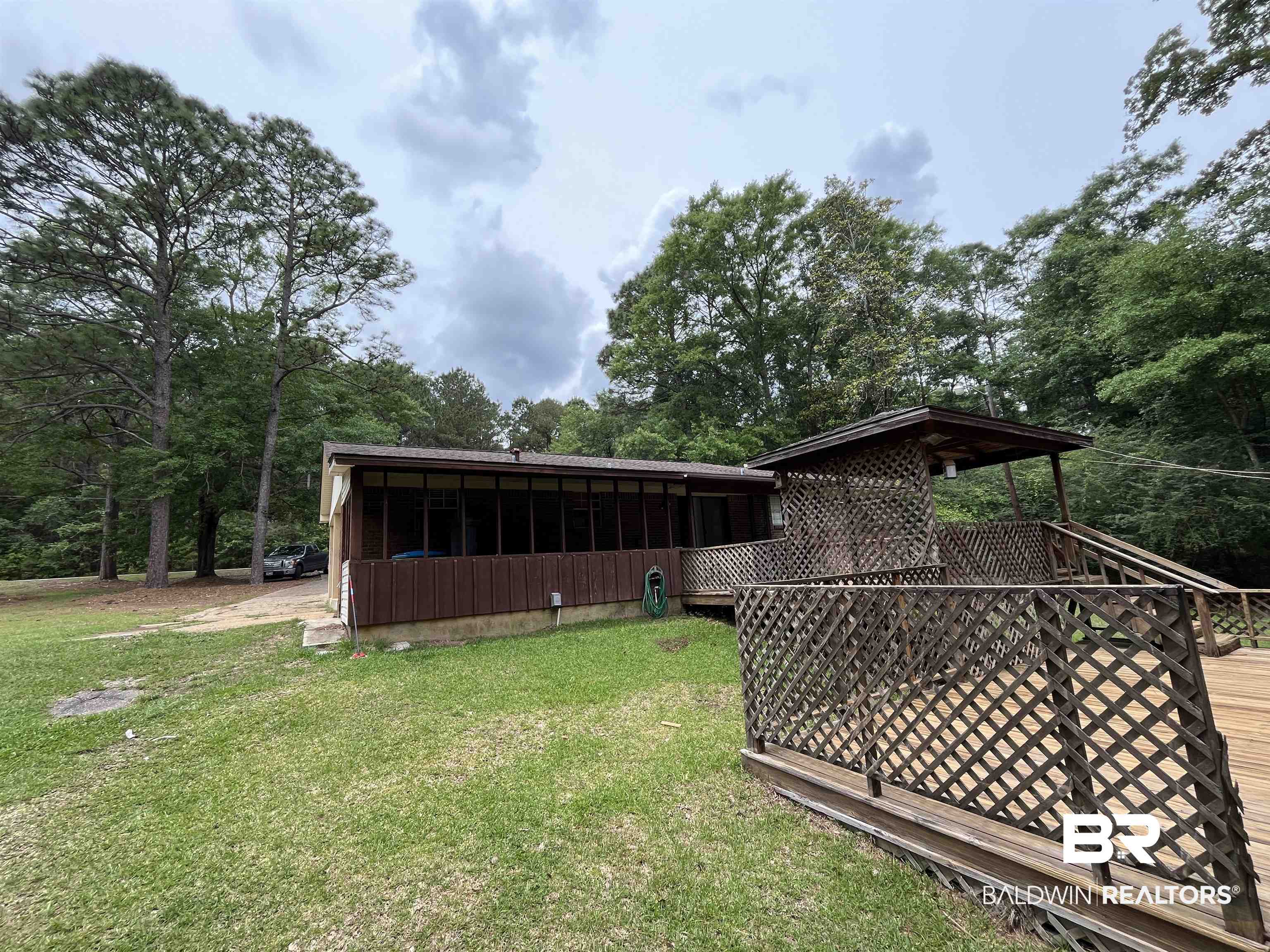 1905 Rockaway Creek Road Atmore, AL 36502 - Photo 4 of 23 Wood-clad exterior featuring a full-length screened porch