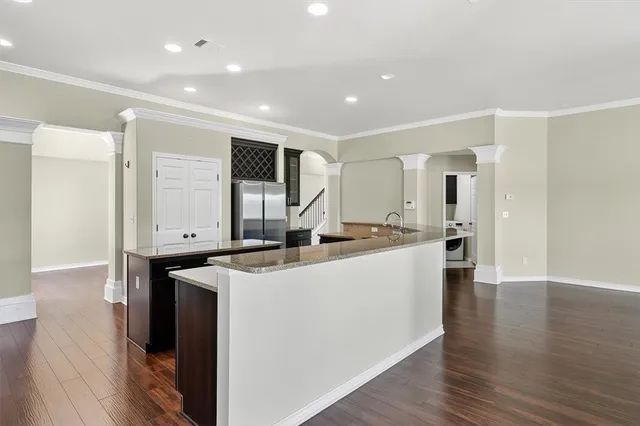 a kitchen with stainless steel appliances a sink and a refrigerator