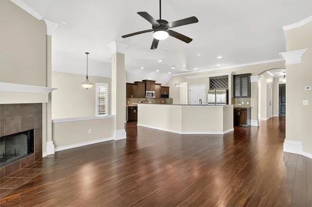 a view of a kitchen with a stove wooden floor and a ceiling fan