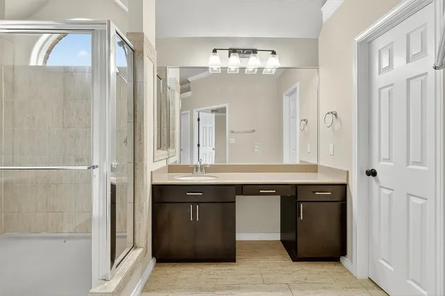 a view of a bathroom with a sink and a mirror