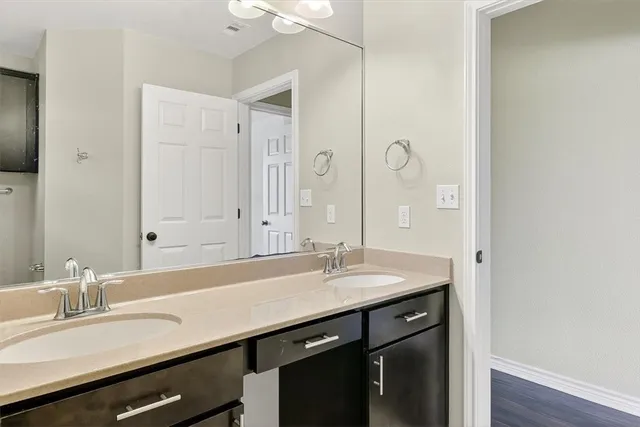 a bathroom with a sink double vanity and a mirror