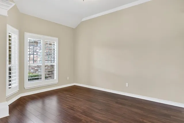 a view of a room with wooden floor and window