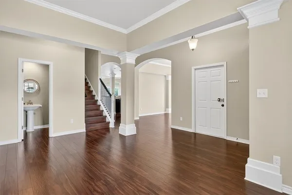 a view of an empty room with wooden floor