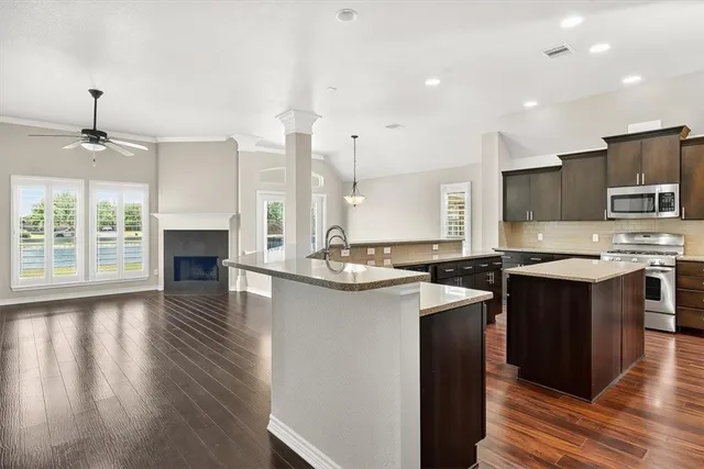 a kitchen with stainless steel appliances granite countertop a sink stove and refrigerator