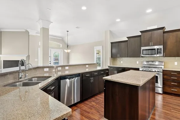 a kitchen with a sink stove a sink and a microwave