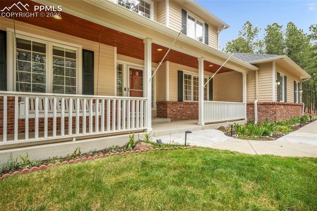 19010 Deerfield Road Monument, CO 80132 - Photo 2 of 50 a view of a house with a yard and pathway