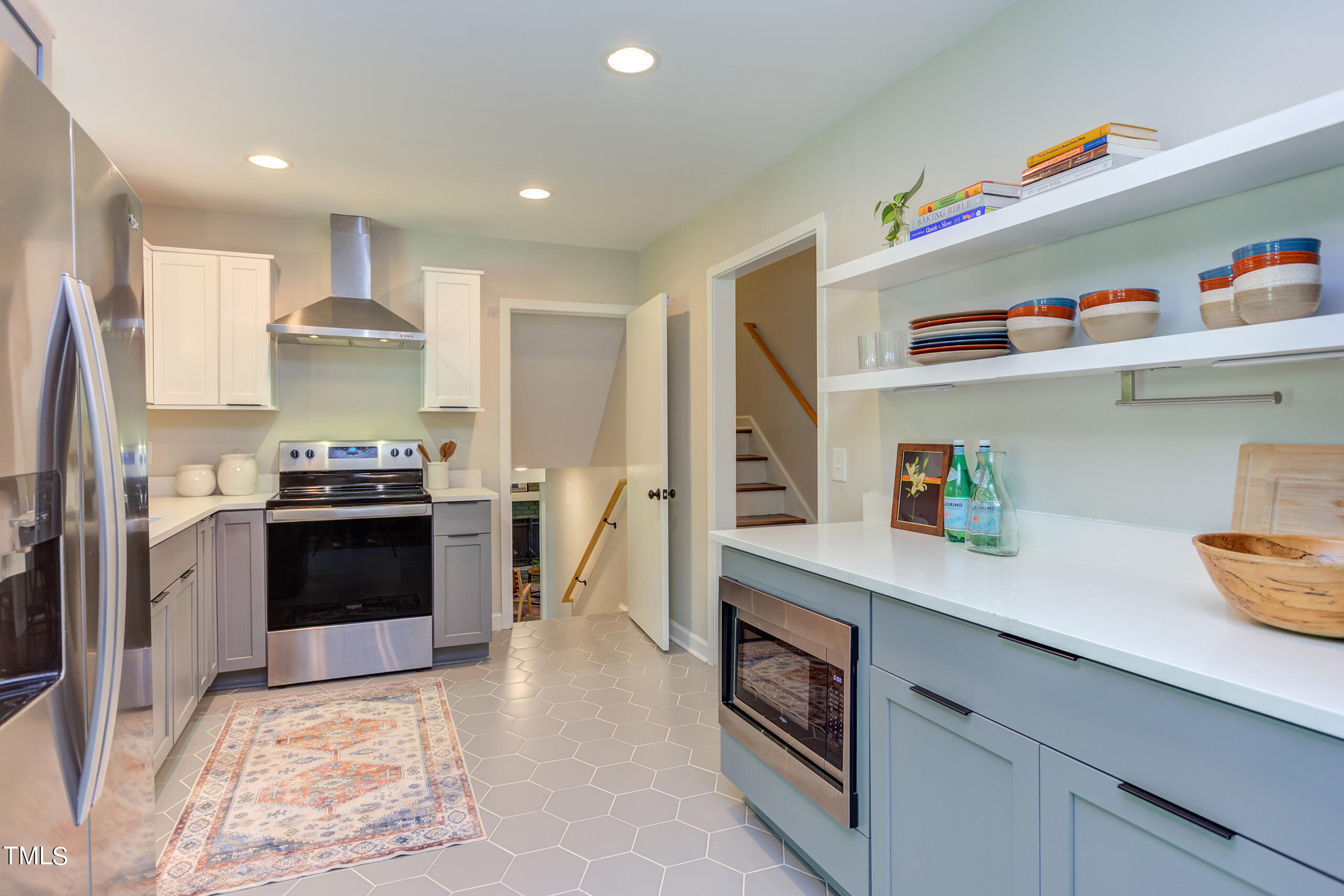 142 Chateau Road Durham, NC 27704 - Photo 14 of 45 a kitchen with kitchen island white cabinets and appliances