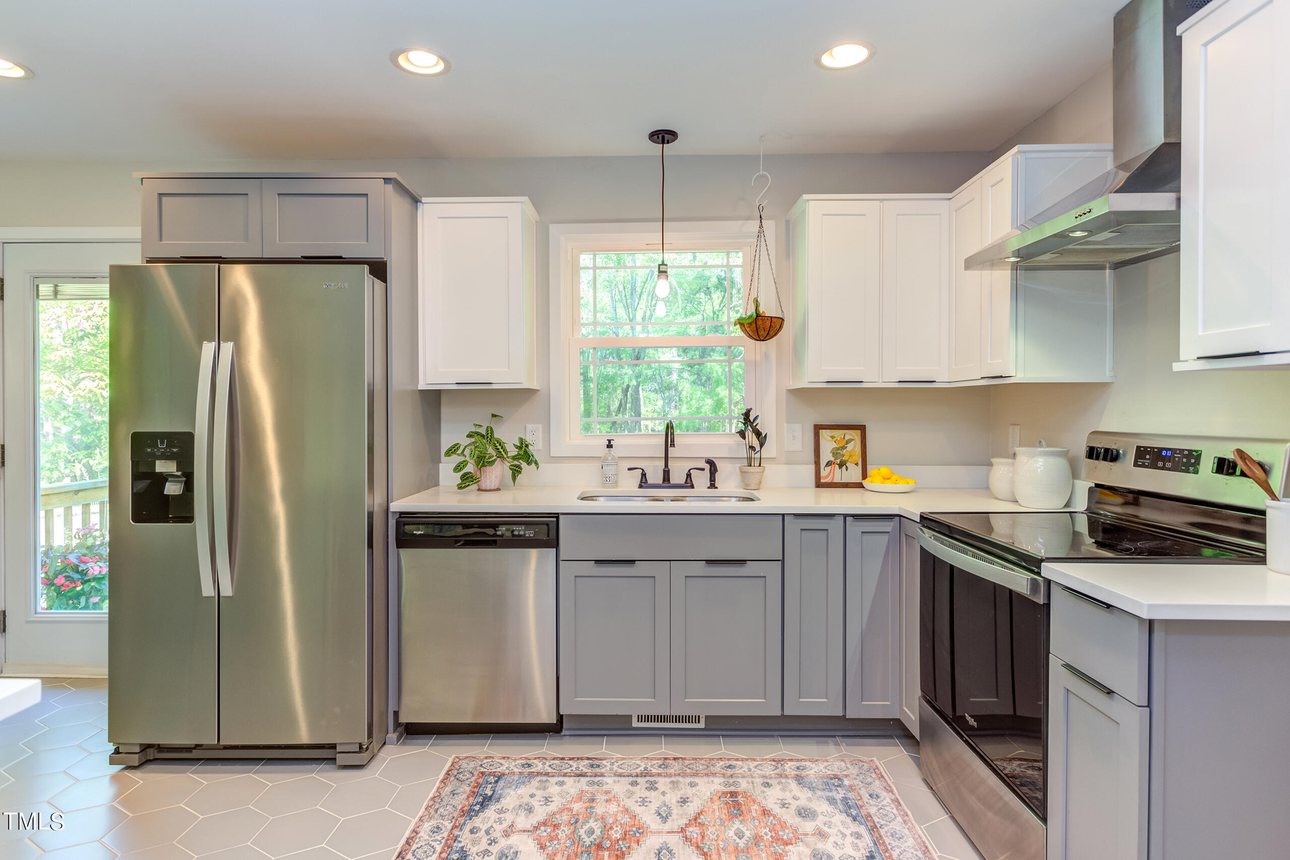 142 Chateau Road Durham, NC 27704 - Photo 18 of 45 a kitchen with stainless steel appliances a sink cabinets and a window