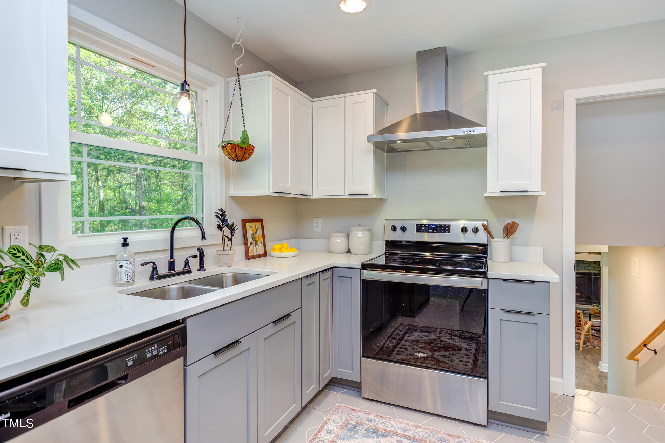 142 Chateau Road Durham, NC 27704 - Photo 19 of 45 a kitchen with stainless steel appliances a sink stove and cabinets