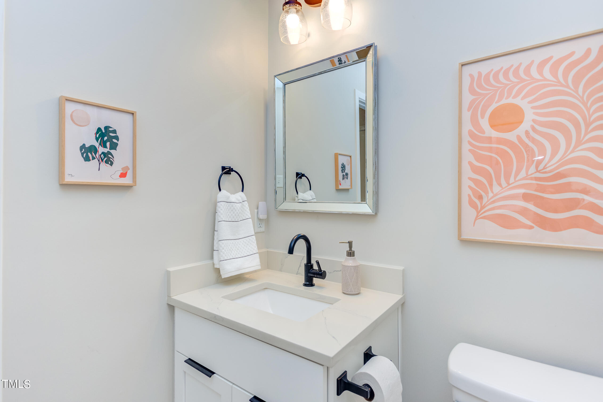 142 Chateau Road Durham, NC 27704 - Photo 28 of 45 a bathroom with a toilet sink and mirror