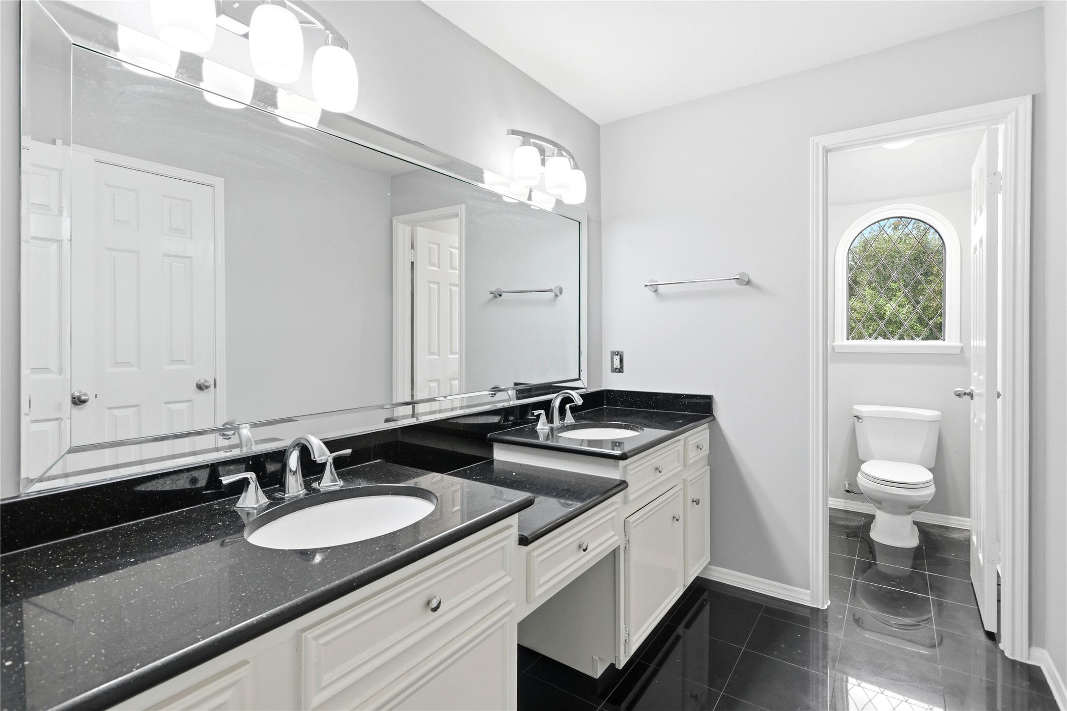 11507 Del Monte Drive Houston, TX 77077 - Photo 34 of 44 Upstairs bathroom with double sinks and vanity.