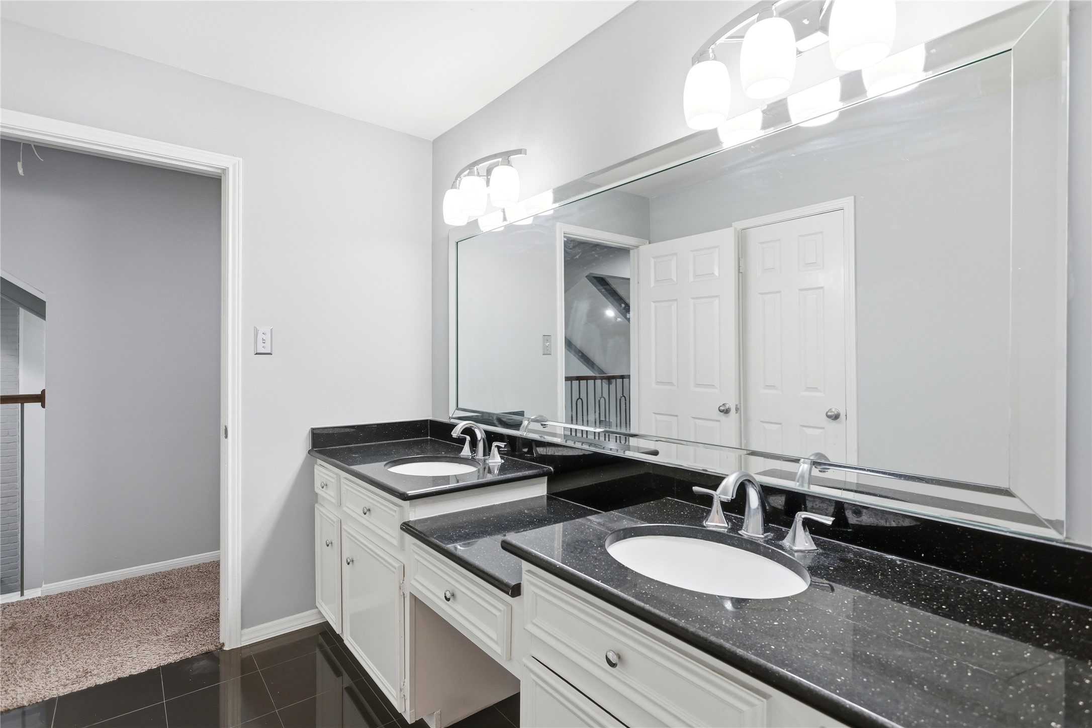 11507 Del Monte Drive Houston, TX 77077 - Photo 35 of 44 Upstairs bathroom with double sinks and vanity.