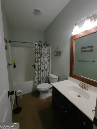 a living room with a flat screen tv and a lamp
