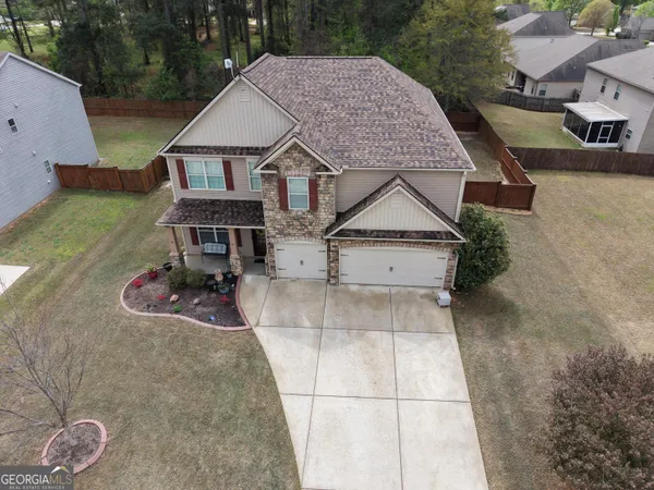 an aerial view of a house with roof deck front of house