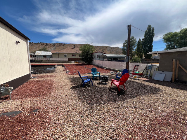 419 2nd E Street Helper, UT 84526 - Photo 27 of 36 Outdoor space featuring varied wood chip ground cover and a fire pit