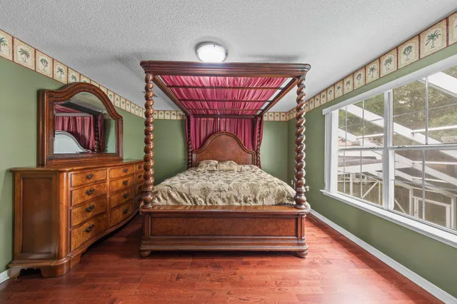 a bed sitting in a bedroom next to a window