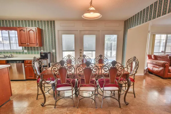 a kitchen with stainless steel appliances granite countertop a stove top oven a sink dishwasher and wooden cabinets