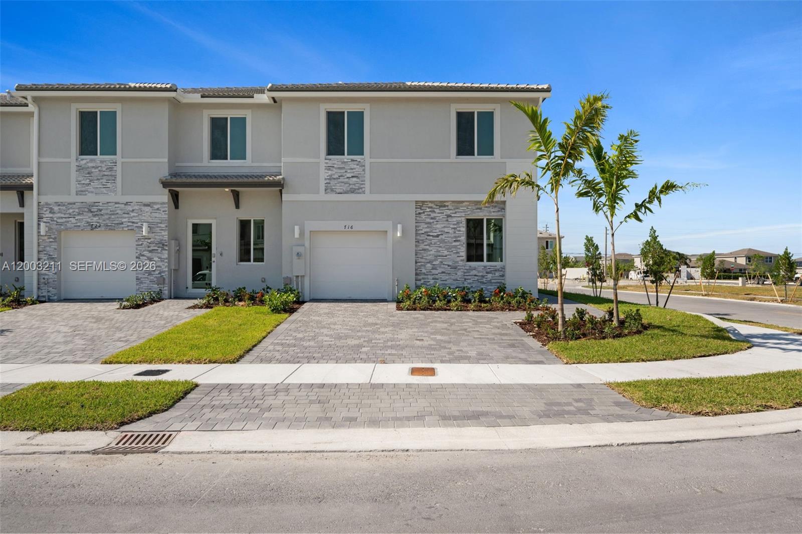715 Southeast 15th Street Homestead, FL 33034 - Photo 1 of 38 a view of a white house with a yard and plants