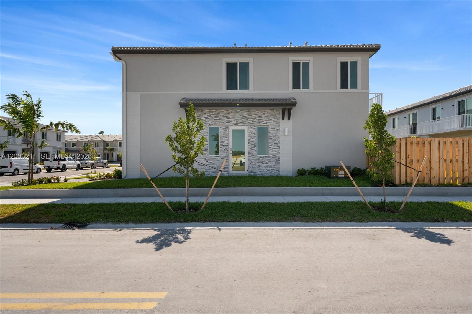 715 Southeast 15th Street Homestead, FL 33034 - Photo 3 of 38 a front view of a house with a yard