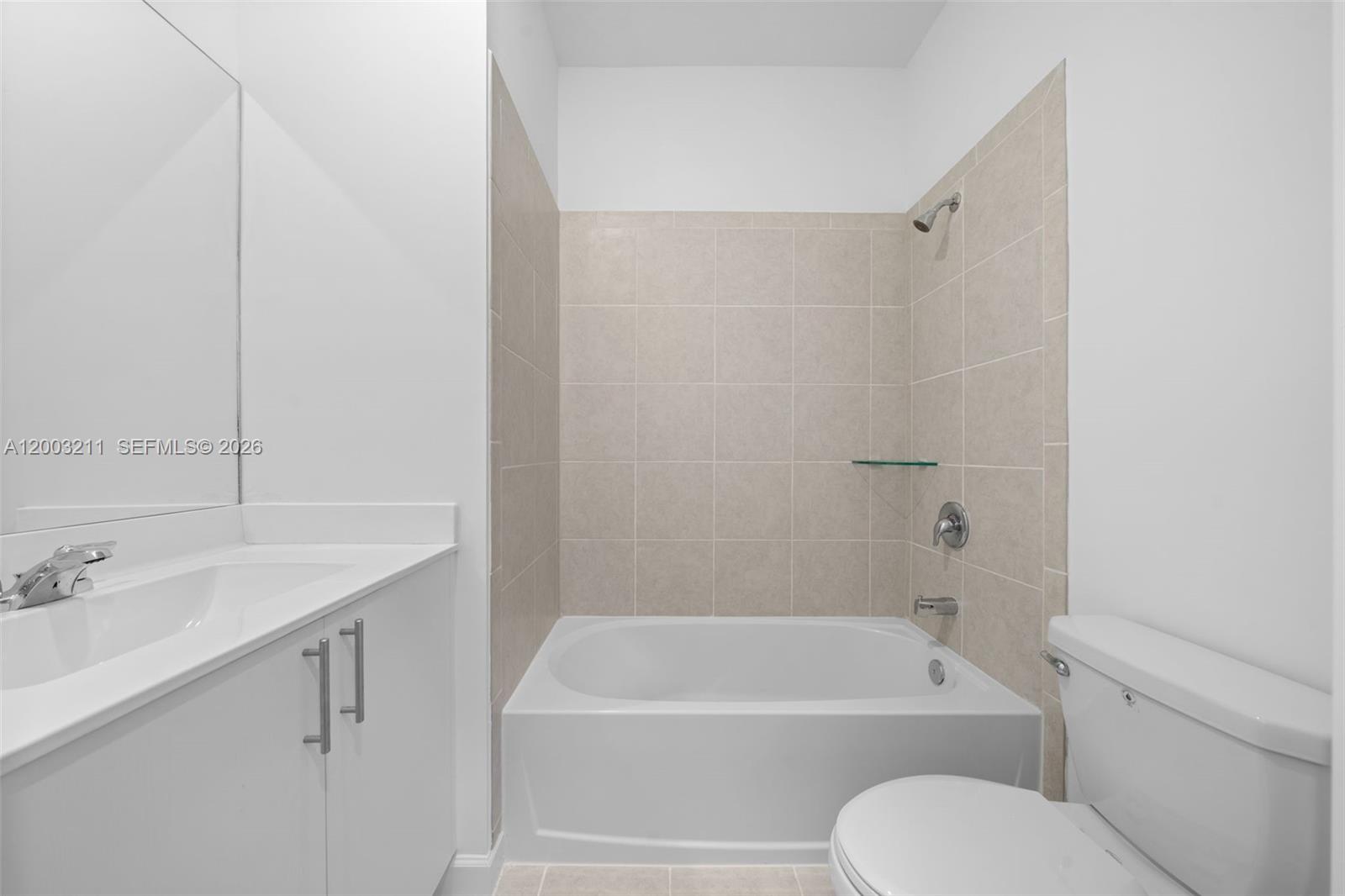 715 Southeast 15th Street Homestead, FL 33034 - Photo 32 of 38 a bathroom with a tub shower sink vanity and toilet