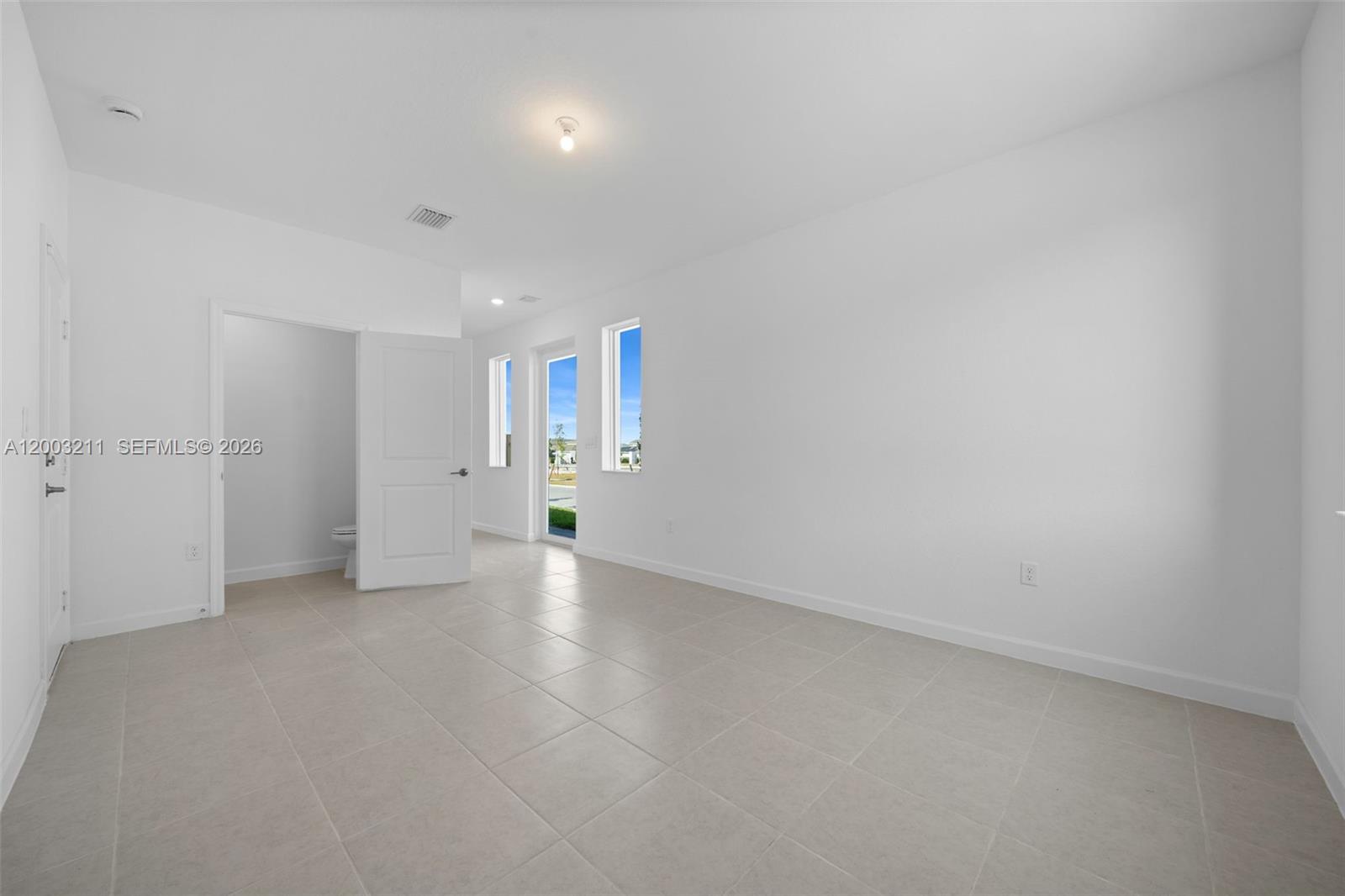 715 Southeast 15th Street Homestead, FL 33034 - Photo 5 of 38 a view of an empty room with a window