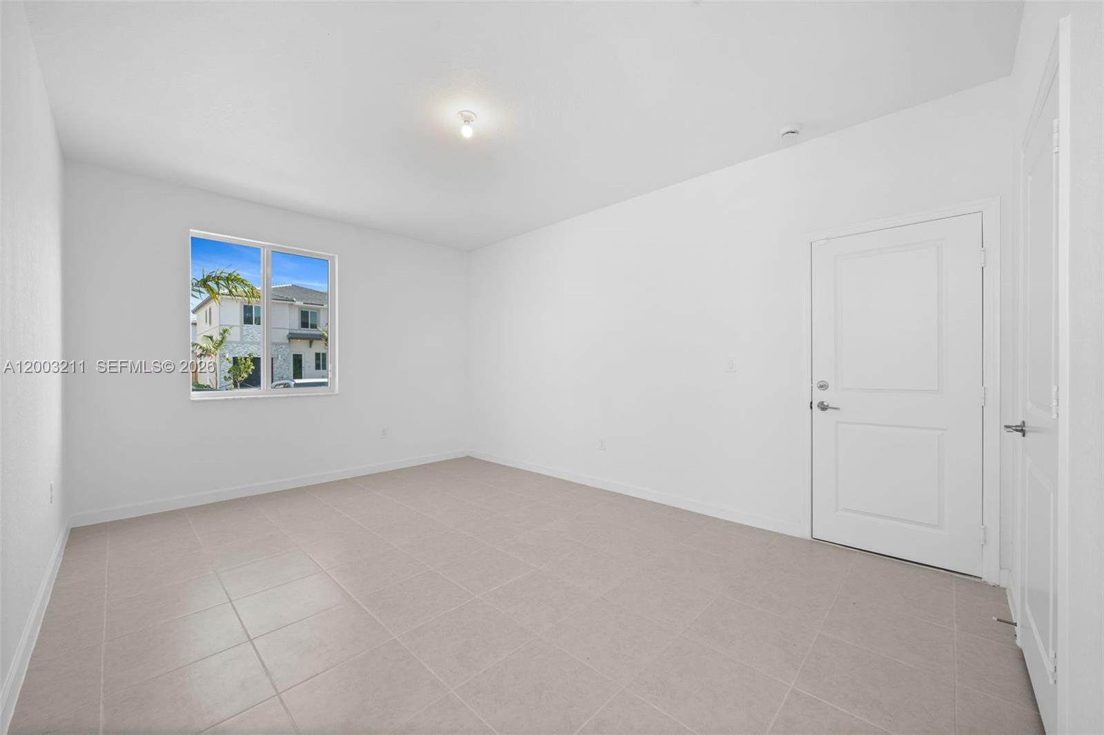 715 Southeast 15th Street Homestead, FL 33034 - Photo 7 of 38 an empty room with windows