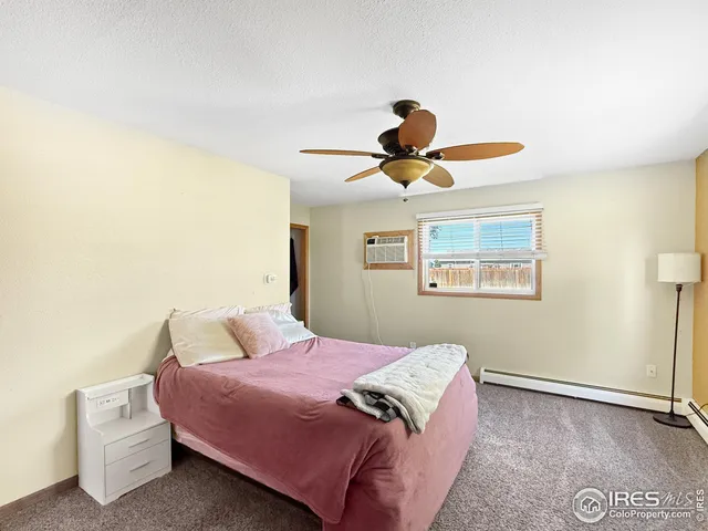 a bedroom with a bed and a ceiling fan
