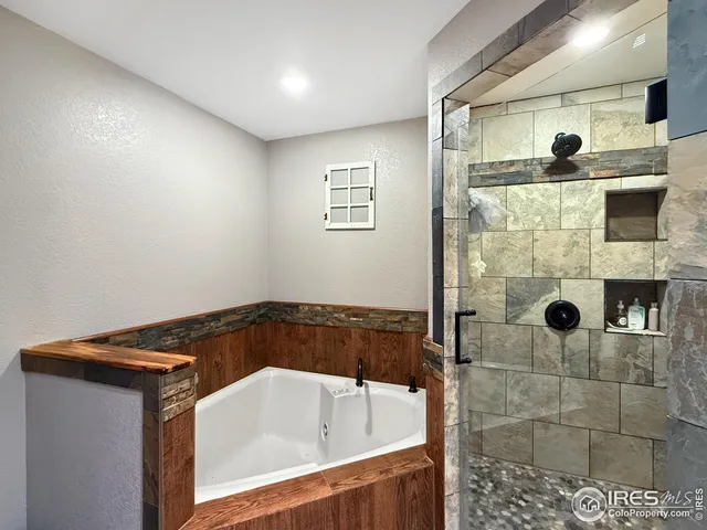 a bathroom with a bathtub and shower