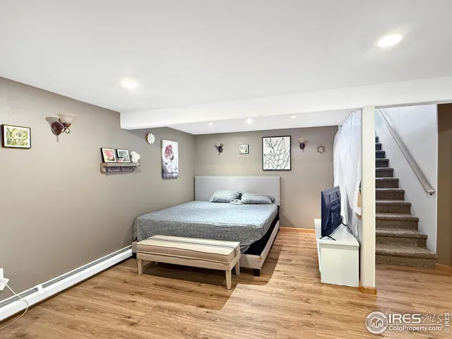 a bedroom with furniture and wooden floor
