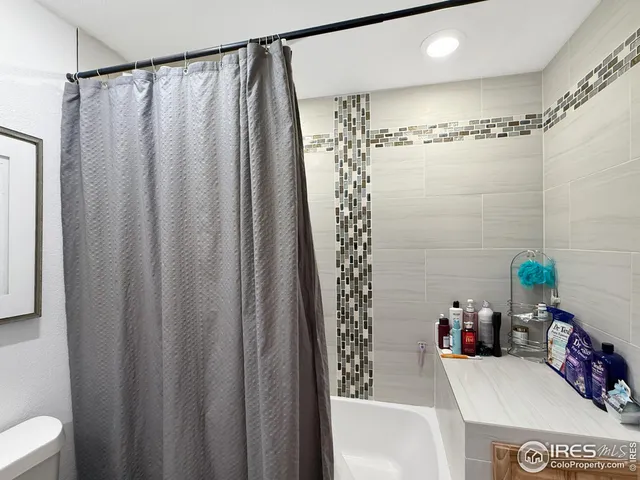 a bathroom with a sink and a shower curtain