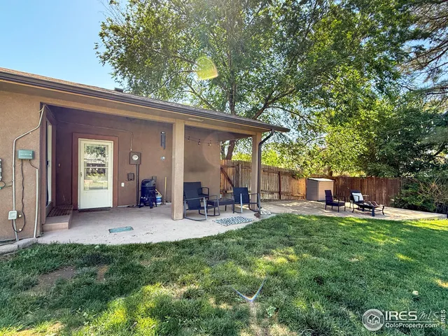 a front view of a house with patio and garden