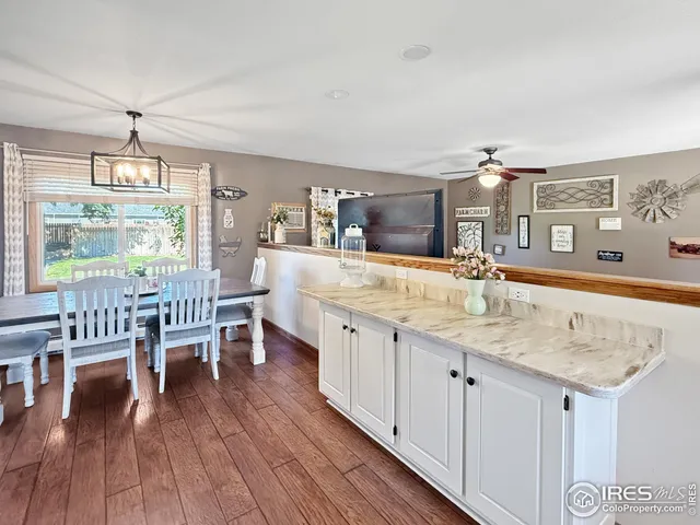 a view of a kitchen counter space with wooden floor and staircase