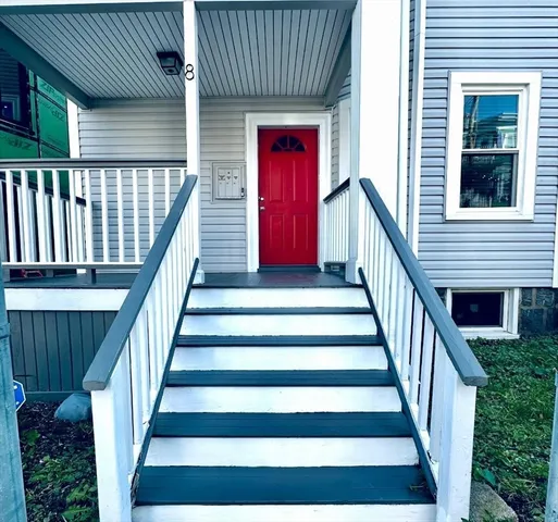a view of entryway with wooden floor and a front door