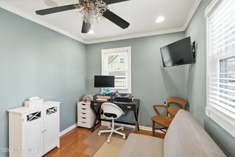 a view of a workspace with furniture and a window