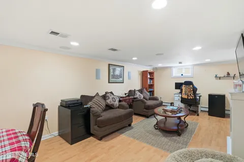 a living room with furniture a couch and a flat screen tv