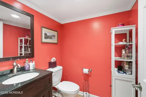 a bathroom with a toilet a sink and mirror