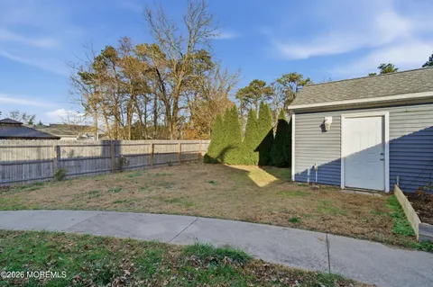a view of a house with a yard and a tree