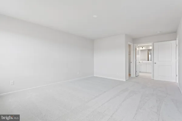 a view of an empty room and closet area