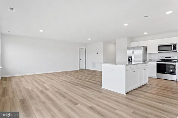 a view of kitchen with granite countertop cabinets and wooden floor