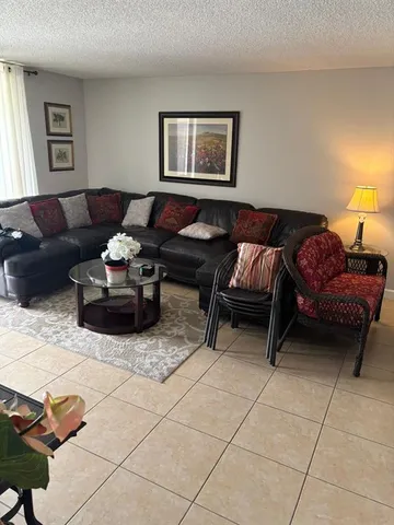 a view of a hallway with a couch and a window