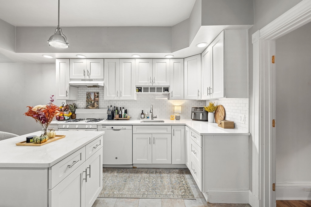 37 M Street Boston, MA 02127 - Photo 15 of 42 a kitchen with kitchen island granite countertop a sink cabinets and stainless steel appliances