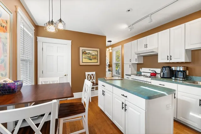 a kitchen with a sink cabinets and window