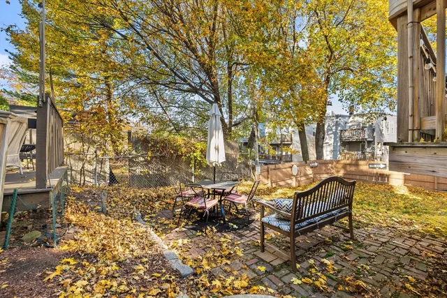 a view of a patio with iron fence