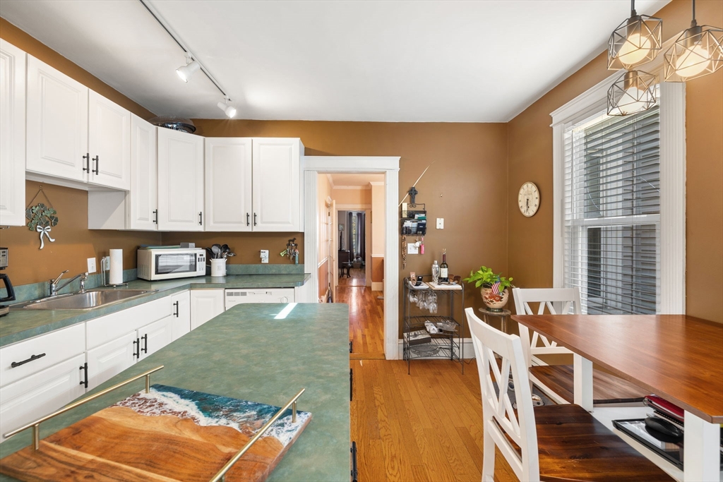37 M Street Boston, MA 02127 - Photo 22 of 42 a kitchen with stainless steel appliances granite countertop a stove a sink dishwasher and cabinets with wooden floor