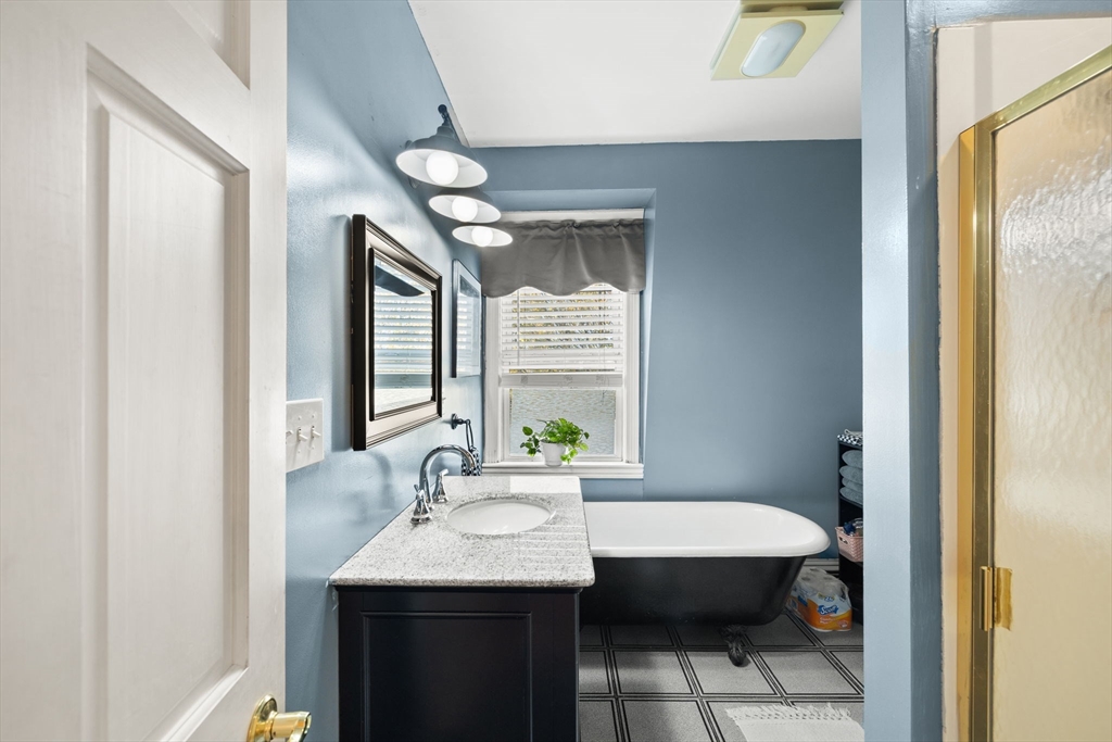 37 M Street Boston, MA 02127 - Photo 29 of 42 a bathroom with a granite countertop sink and a mirror