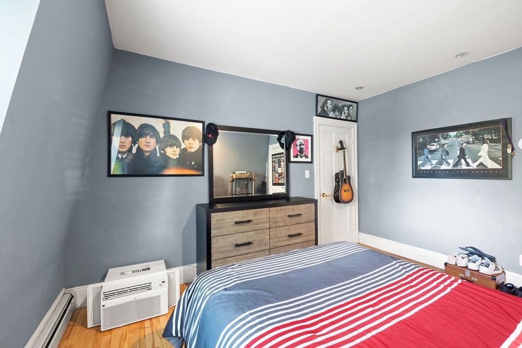 37 M Street Boston, MA 02127 - Photo 31 of 42 a bedroom with a bed and a tv on the dresser