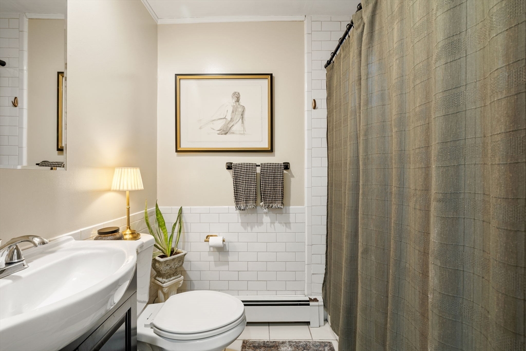 37 M Street Boston, MA 02127 - Photo 8 of 42 a bathroom with a toilet a sink and mirror