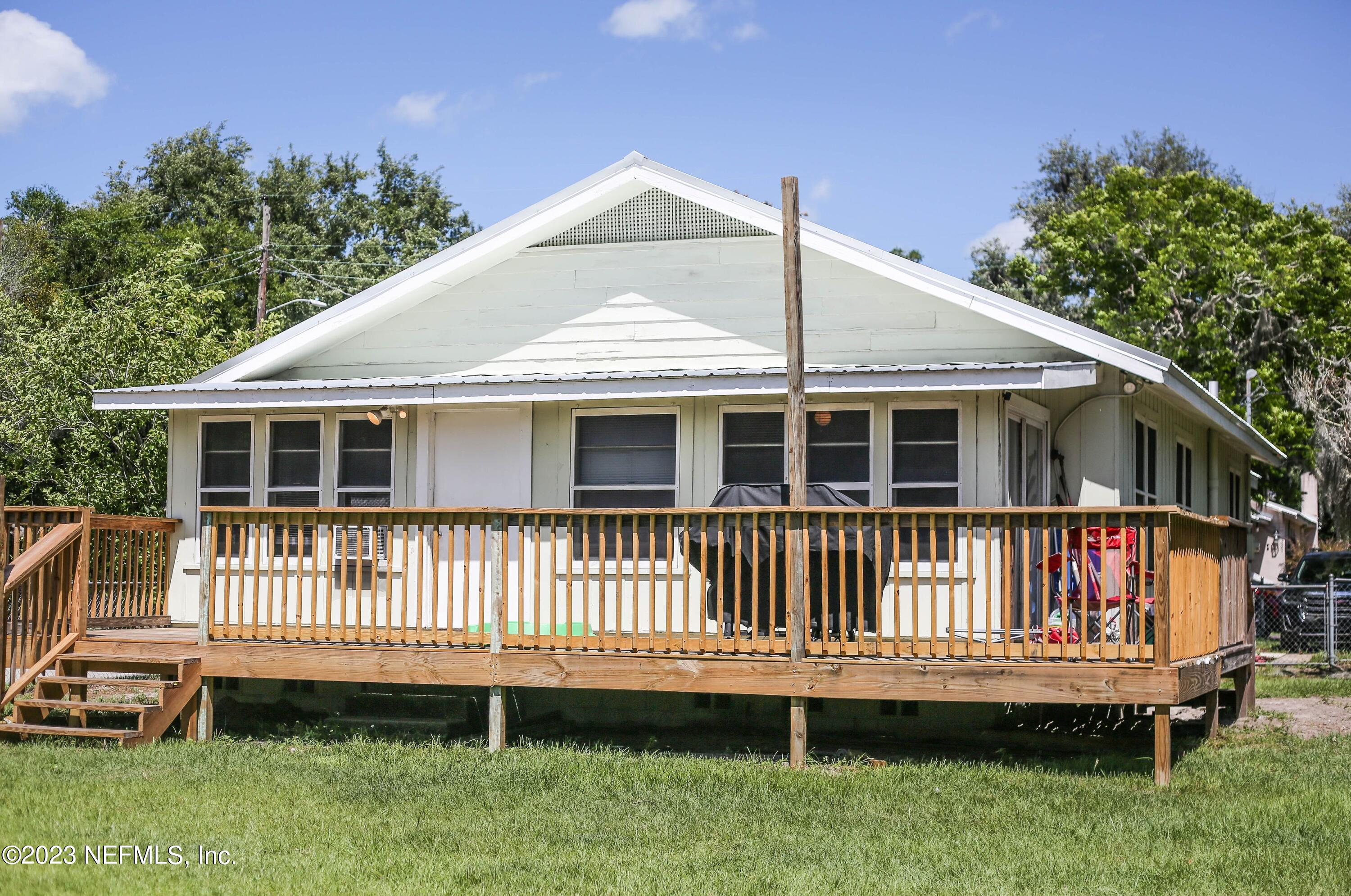 224 Benham Street Palatka, FL 32177 - Photo 14 of 15 a view of a house with a backyard and deck