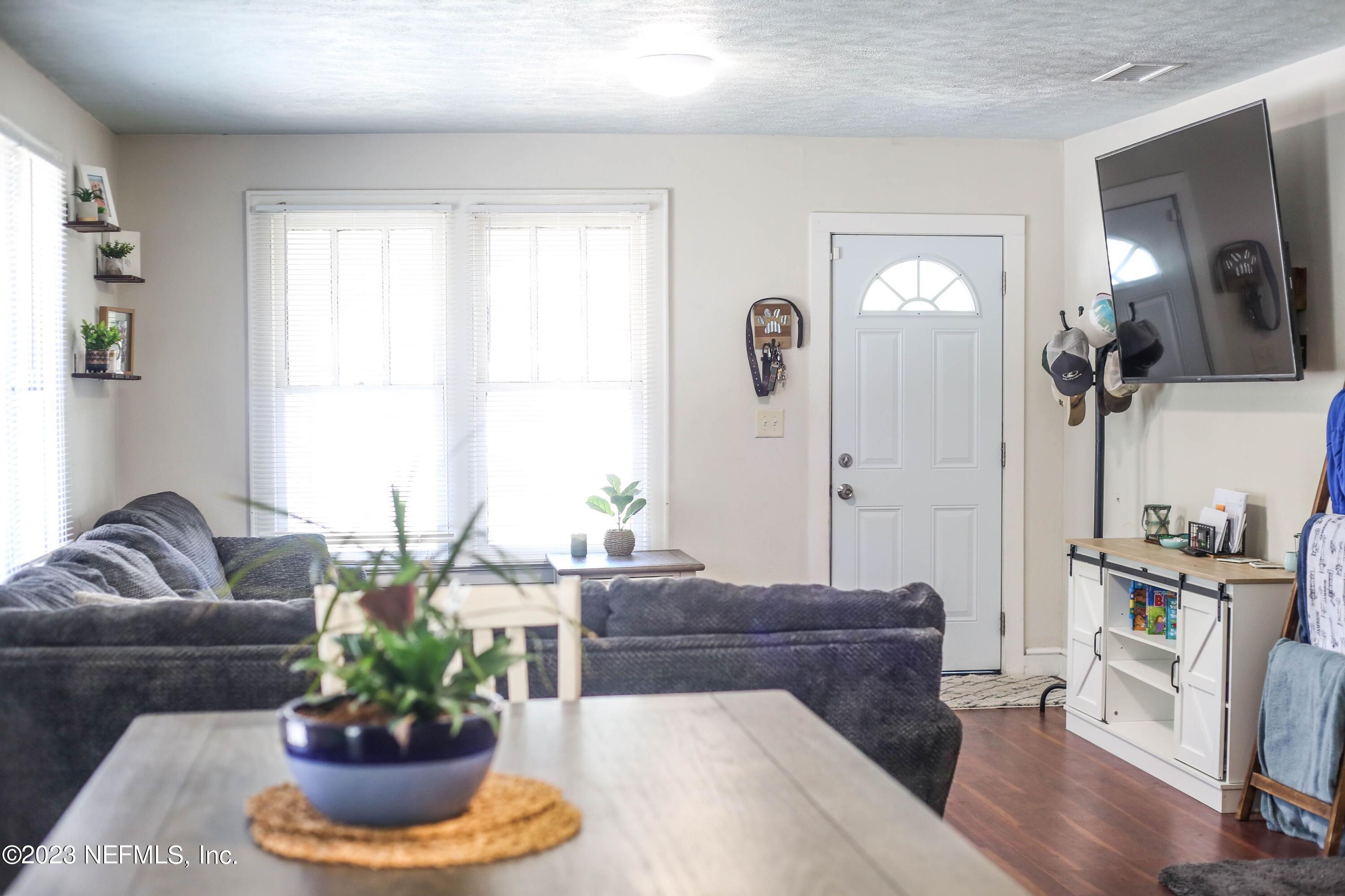 224 Benham Street Palatka, FL 32177 - Photo 3 of 15 a living room with a couch and a potted plant