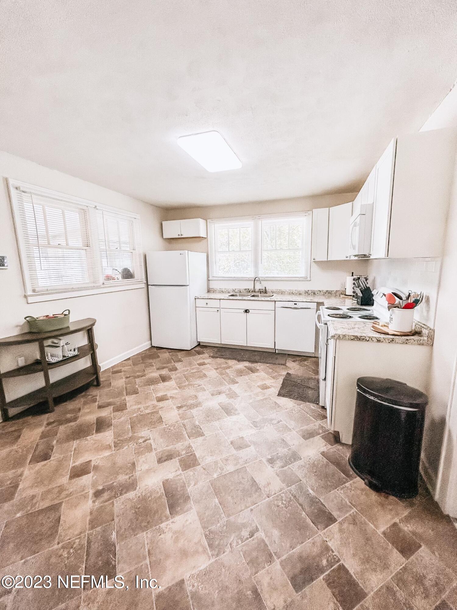 224 Benham Street Palatka, FL 32177 - Photo 5 of 15 a kitchen with a stove a sink and a refrigerator